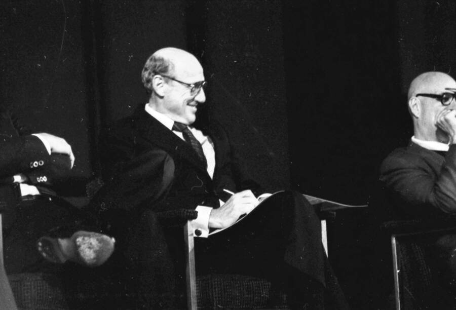 President Gibb sitting on stage during a presentation.