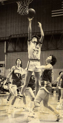 Vandals basketball player Mary Raese (23) going up for a shot against University of Montana Bobcats.