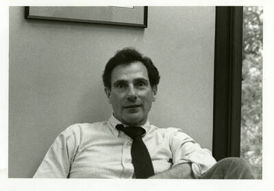 Raymond Miller, Dean of Agriculture, sitting with an odd facial expression.