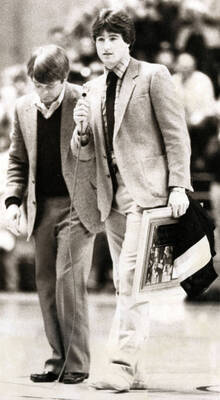 Coach Dennis Erickson helps honor graduating senior Ken Hobart in the Kibbie Dome.