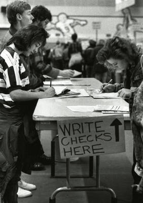 Students paying for their classes by check in the Kibbie Dome during Registration Day.