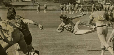 Students playing football outside.