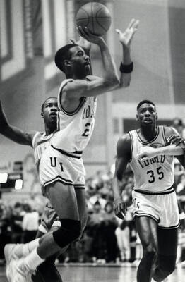 Idaho guard Caesar Prelow pulls up for a jump shot vs. the University of Montana as teammate Raymond Brown looks on.
