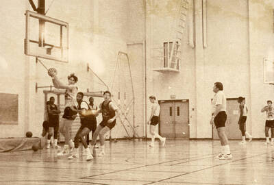 Men's basketball practice with Coach Bill Trumbo observing.