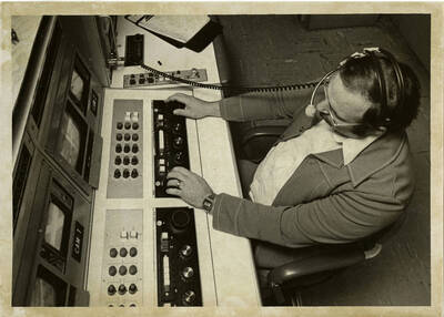 Man operating video editing equipment.