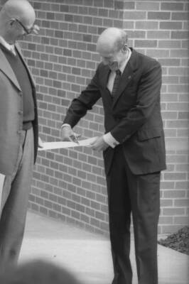 President Gibb preparing to cut the ribbon on a new campus construction project.