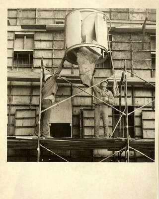 Construction workers building Kibbie Dome annex.