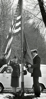A female soldier salutes the American flag as it raised.