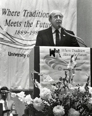 University of Idaho Centennial. Robert Gibb speaking at a podium in front of a banner reading ""Where Tradition Meets the Future 1889-1989.""
