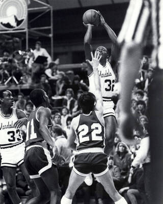A Vandals basketball player making a jump shot.