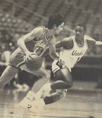 An Idaho basketball player defends an Idaho State University guard.