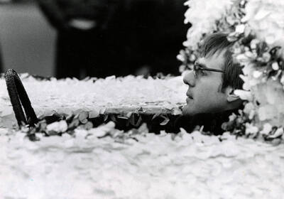 A close-up shot of the driver of a parade float during Homecoming.