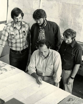 Mines students and faculty examining various data.