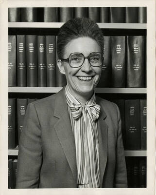 Jean'ne M. Shreeve, Department of Chemistry Professor, smiling in front of a full bookshelf.