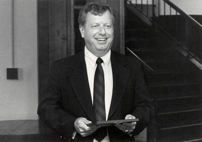 David McKinney, Vice President of Finance & Development holding an award.