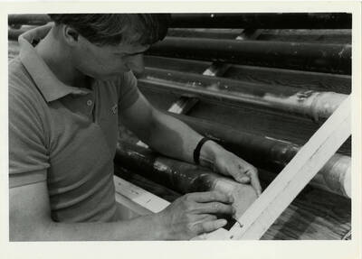 Student assembling a solar heating panel.
