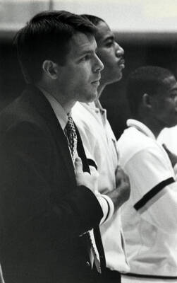 Idaho basketball coach, Tim Floyd, stands for the national anthem along with his players.