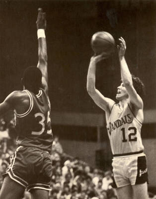 Brian Kellerman (12) of U of I basketball, taking a shot.