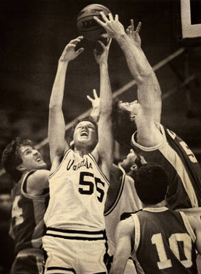 Vandals basketball player Frank Garza (55) jumping up for a rebound.