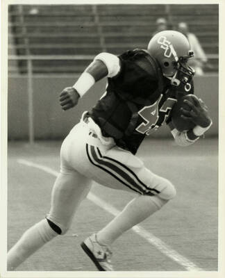 OSU football player running the ball.