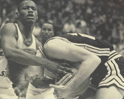 A Vandals basketball player struggling for the ball during a game.