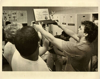 Football team with Big Sky Conference Champions 1985 trophy.