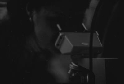 A person looking through a microscope.