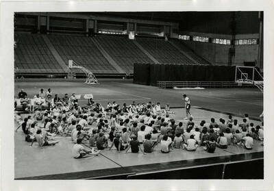 An instructor talking to basketball players at summer basketball camp.