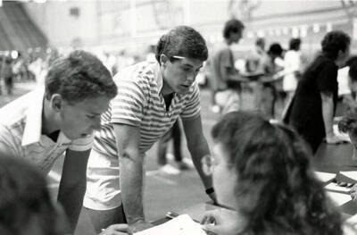 Two students registering for their classes in the Kibbie Dome.