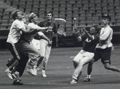 Students chasing a frisbee.