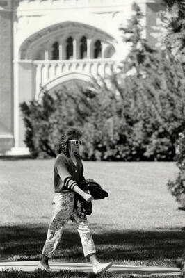 A student walking in front of the Admin Building.