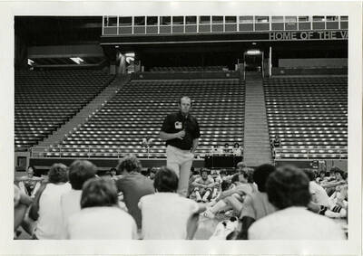 Don Monson talking to basketball players at summer basketball camp.