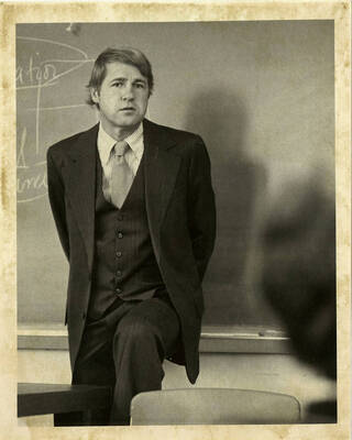 Robert 'Bob' Blank, emeritus professor of Political Science, posing for a picture in front of a chalkboard.
