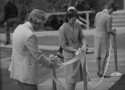 People setting up rope and stanchions.