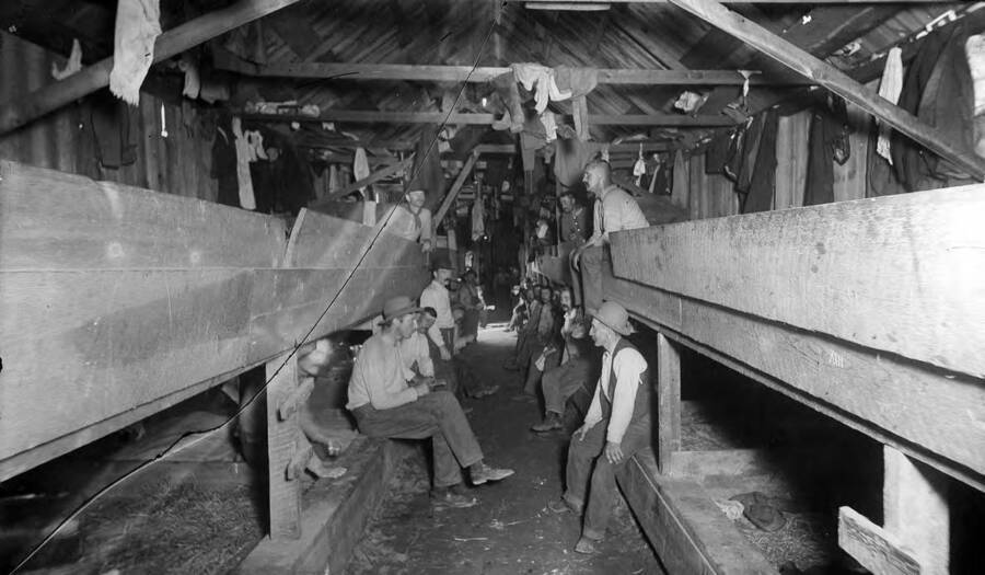 Interior showing bunks and group of men.