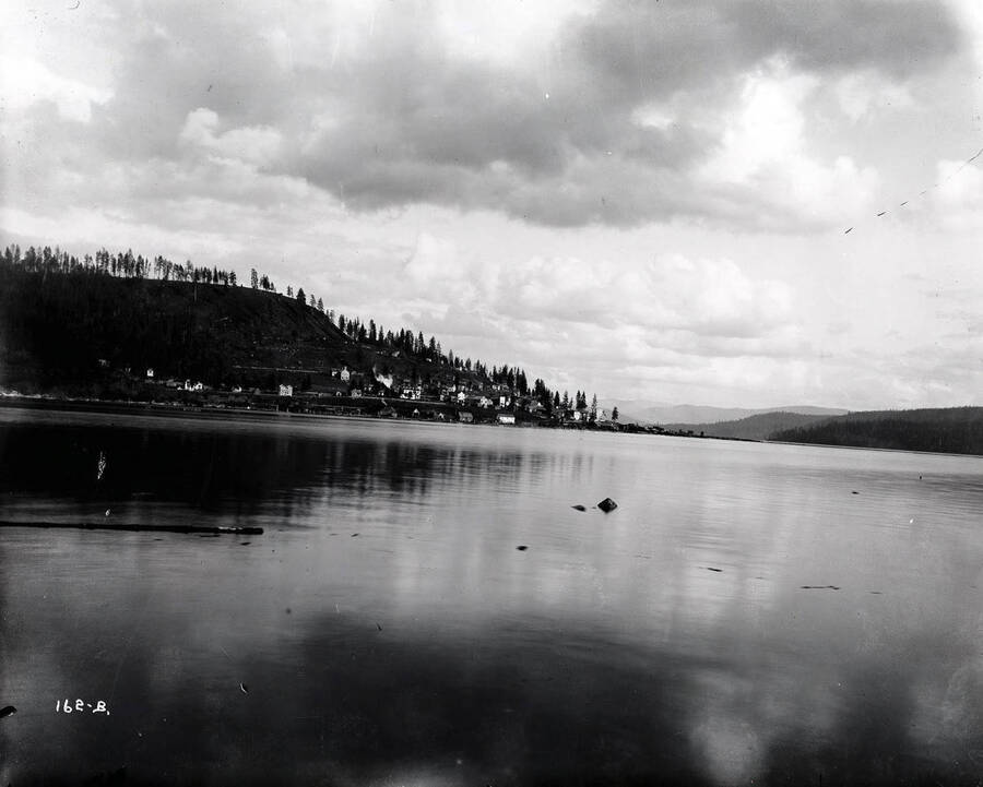 View of Harrison, Idaho, taken from Lake Coeur d'Alene. Deadhead logs can be seen floating in the surrounding water.
