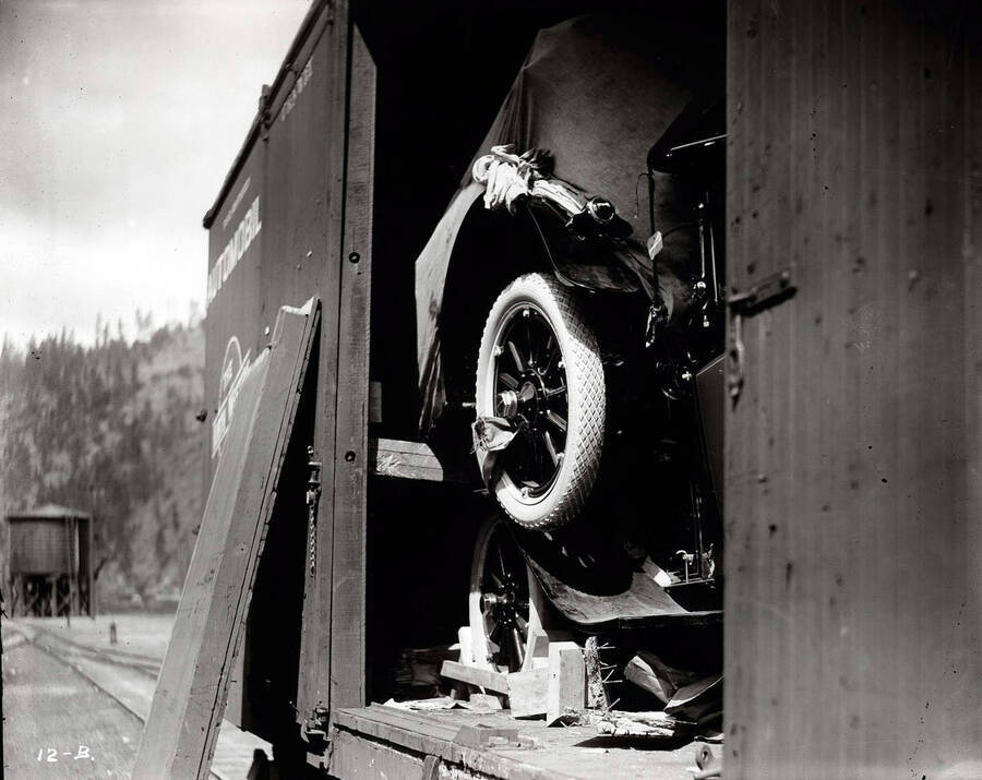 Image shows antique automobiles  - in a railroad car  [1914]. Taken for O.W.R. & N. Co. [Oregon-Washington Railroad and Navigation Company].