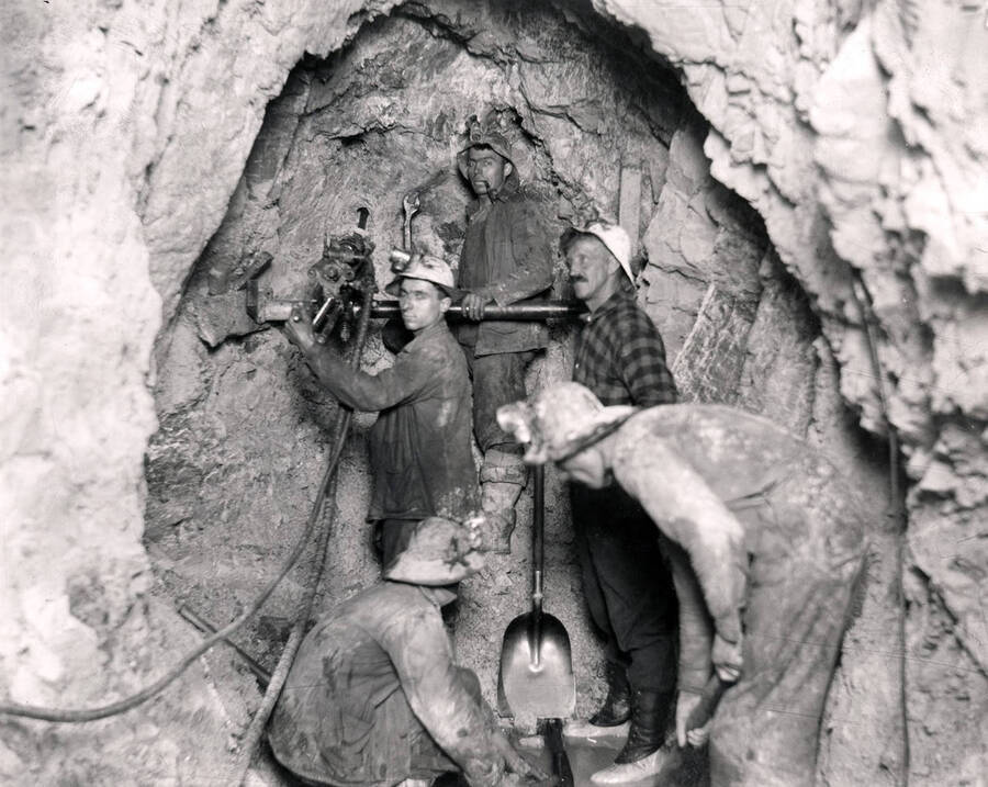 Interior of the Amazon Dixie Mine showing men using crank liner in their stope.
