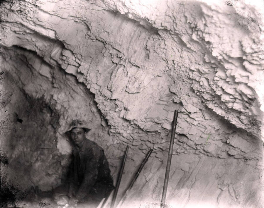 A miner sits inside a tunnel in the Amazon Dixie Mine, 1923.