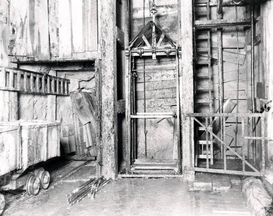 Image shows some ore cars and the elevator going down into the mine at Amazon Dixie Mine, 1923.