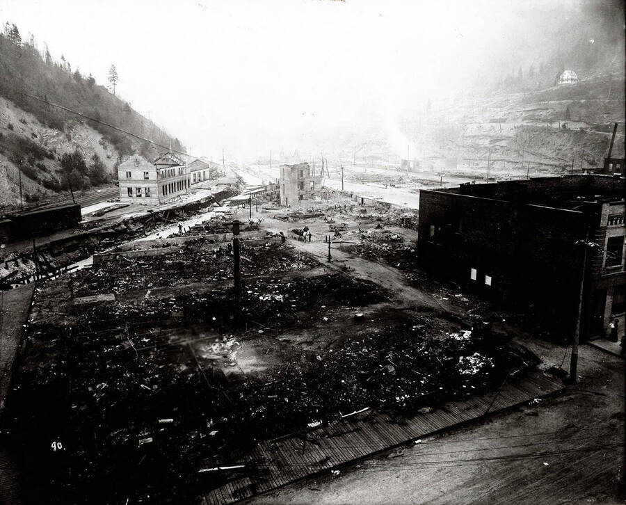Image of Wallace, Idaho after the fire of August 20, 1910.   Caption on front: "General view from Samuel's Hotel, showing Oregon, Washington Railroad and Navigation station, August 20, 1910"