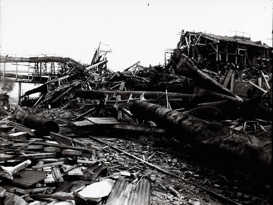 Image shows the debris of Bunker Hill and Sullivan Mill after the explosion in Wardner, Idaho [1899].  Caption on image: "On April 29, 1899 the Miners' Union of Coeur d'Alene destroyed the Bunker Hill Mill and other buildings by dynamite and fire."