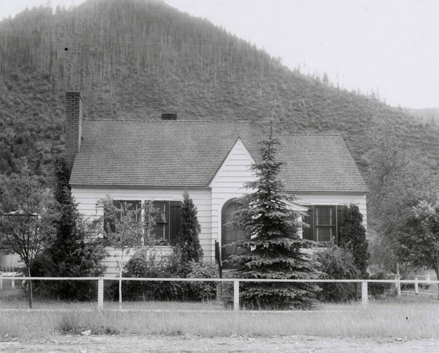 View of a house in Wallace, Idaho with a hill in the background. A real estate view taken for Idaho First National Bank.