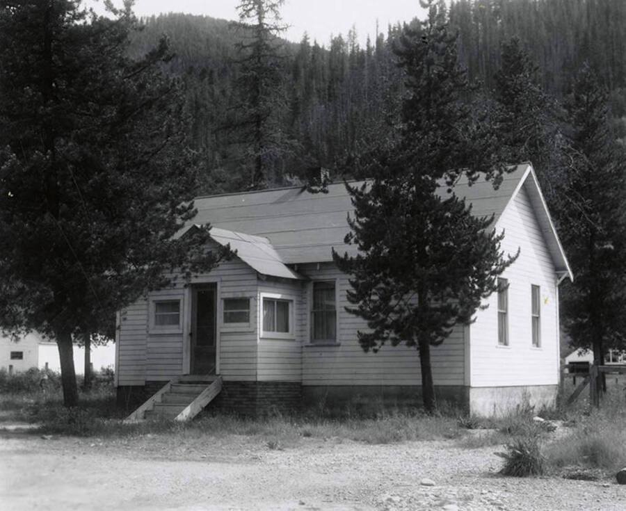 View of a house in Wallace, Idaho surrounded by trees. A real estate view taken for Idaho First National Bank.