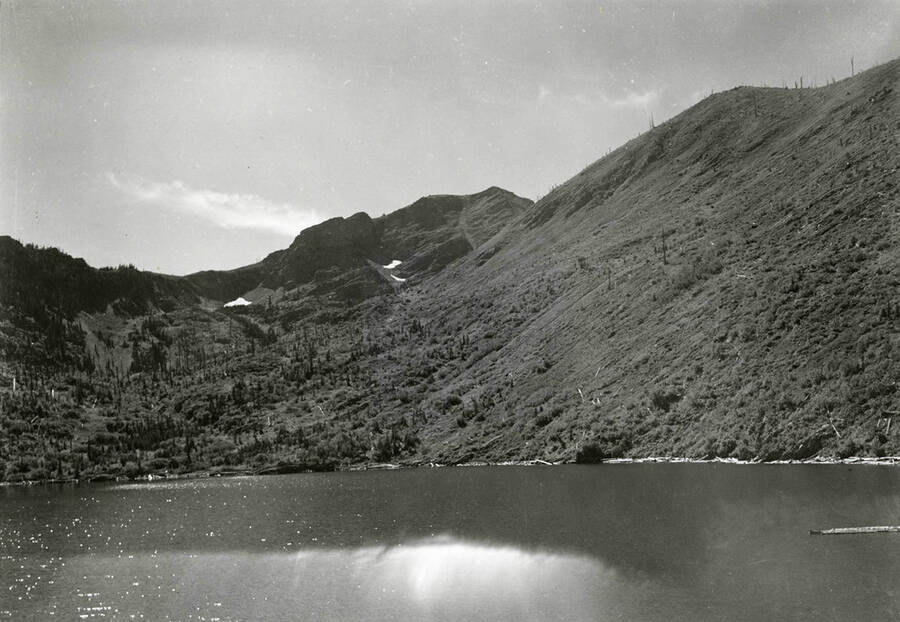 View of Stevens Lake, surrounded by hills and trees.