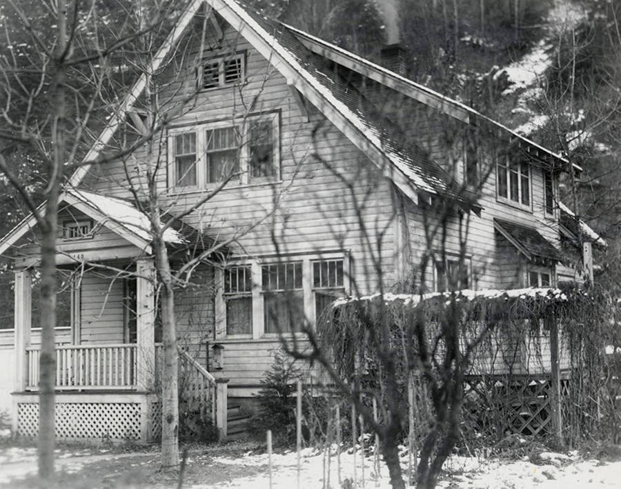 View of a house in Wallace, Idaho with trees behind it. A real estate view taken for Idaho First National Bank.