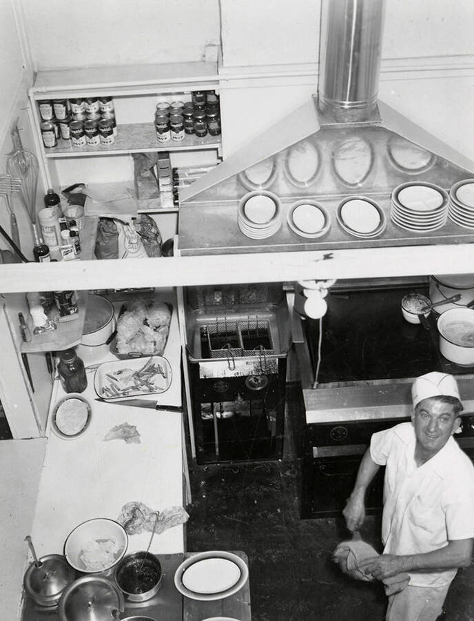 A view looking down on a man cooking in the kitchen at the Silvio Cafe in Wallace, Idaho.