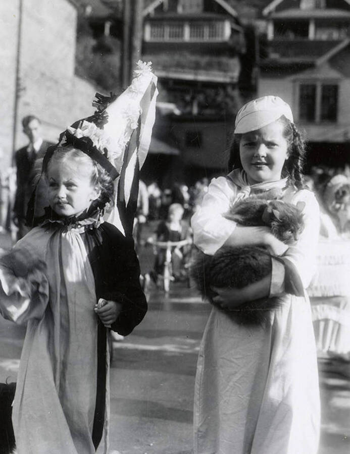 Children dressed up and holding a cat for the Eagles parade in Wallace, Idaho.