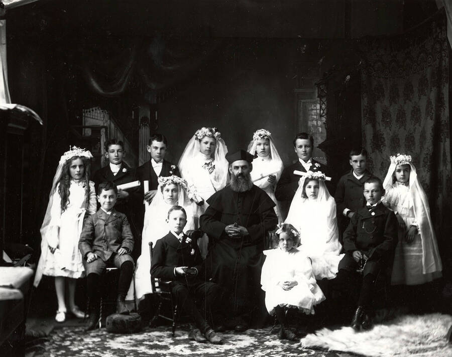 Children who were part of the confirmation class in Wallace, Idaho posing with Father F.A. Becker.
