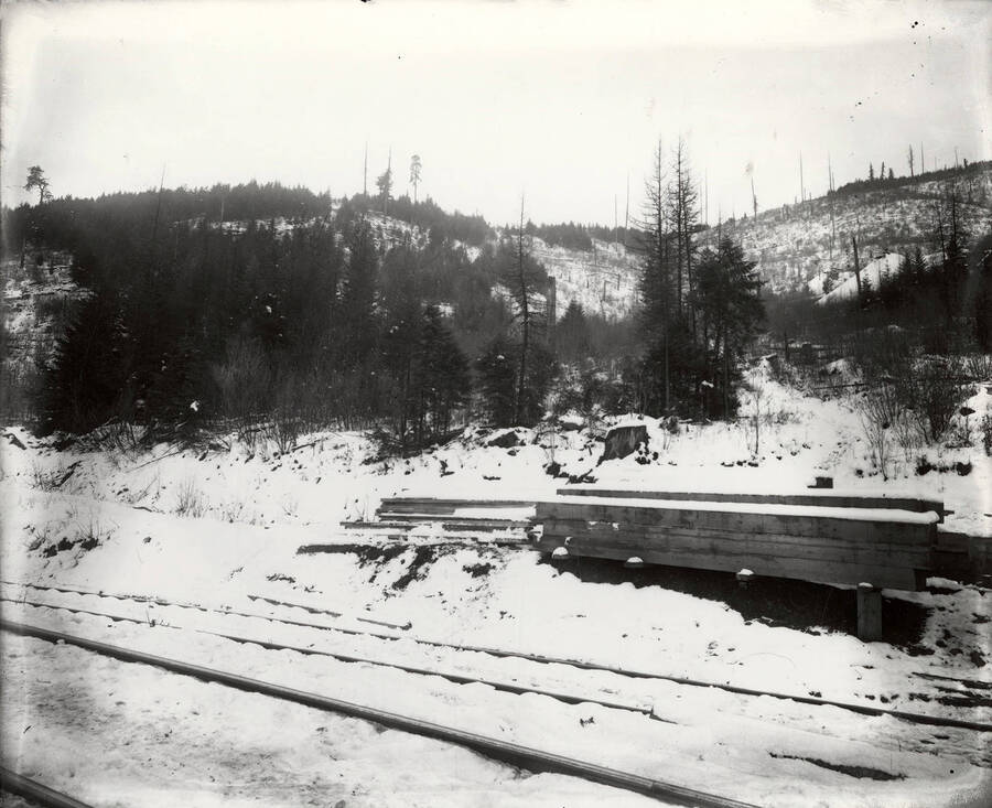 View of the hillside above the railroad tracks covered in snow on Stewart Mine in Wallace, Idaho.